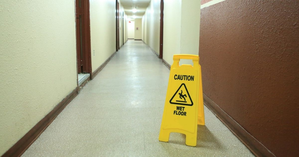 Corridor floor with a wet-floor caution sign