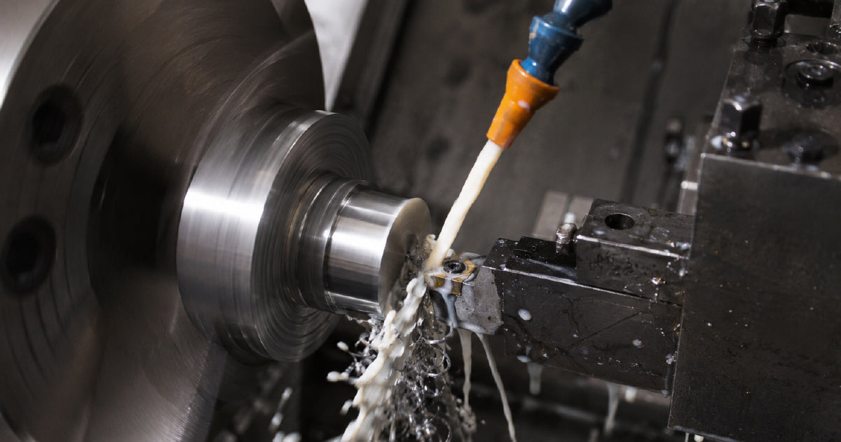 Cutting fluid being applied at cutting zone during metal drilling showing neat oil soluble and synthetic types for machining selection guide Australia