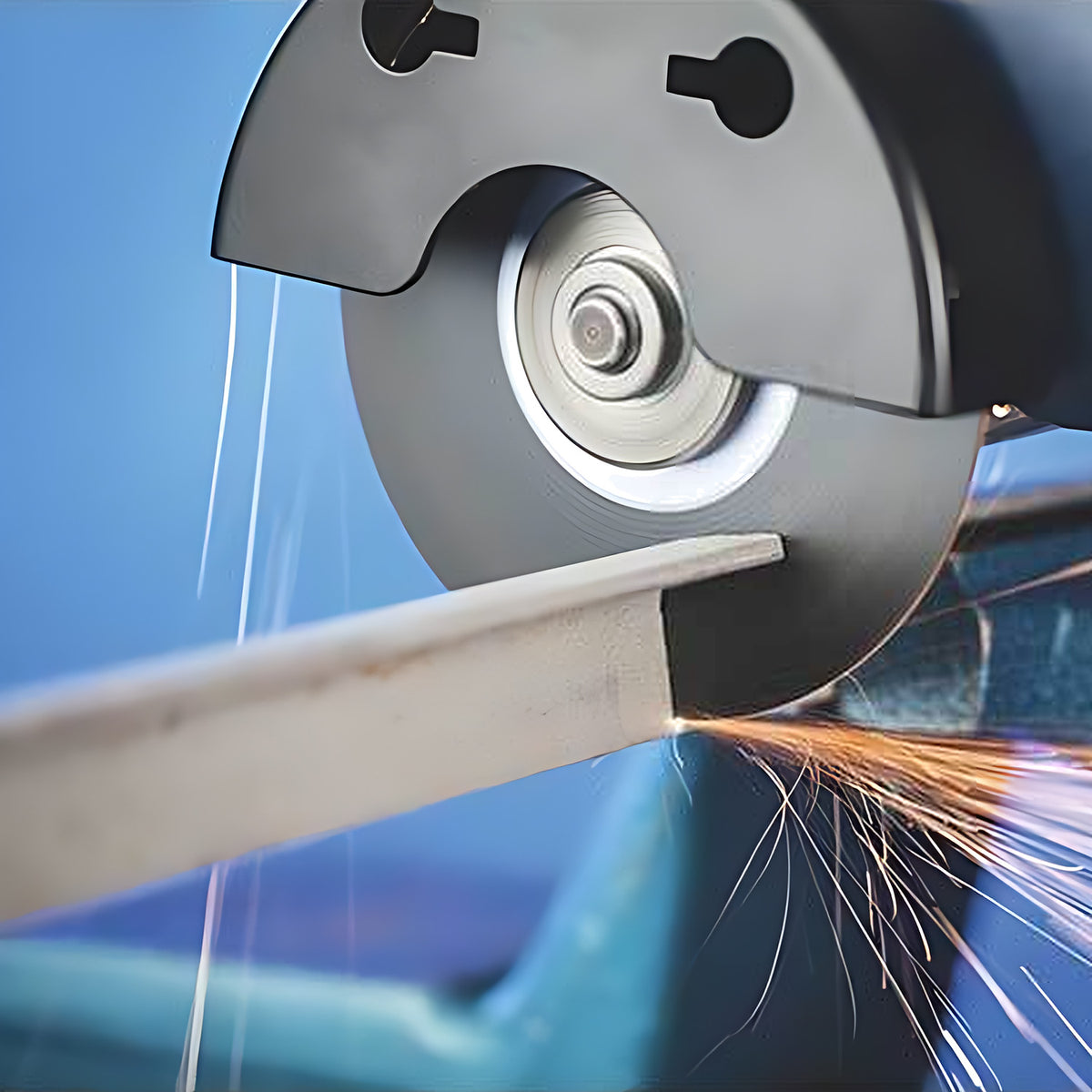 Pferd SG Inox flat cut-off wheel on an angle grinder, cutting a flat bar with sparks, side working shot
