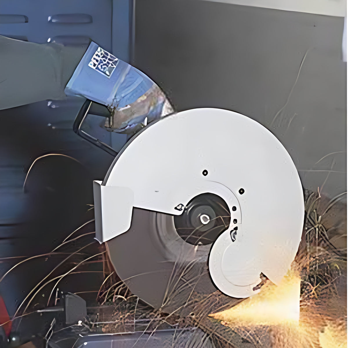 Pferd high speed stationary cut-off wheel in a chop saw with white guard, blue-gloved operator cutting steel with sparks