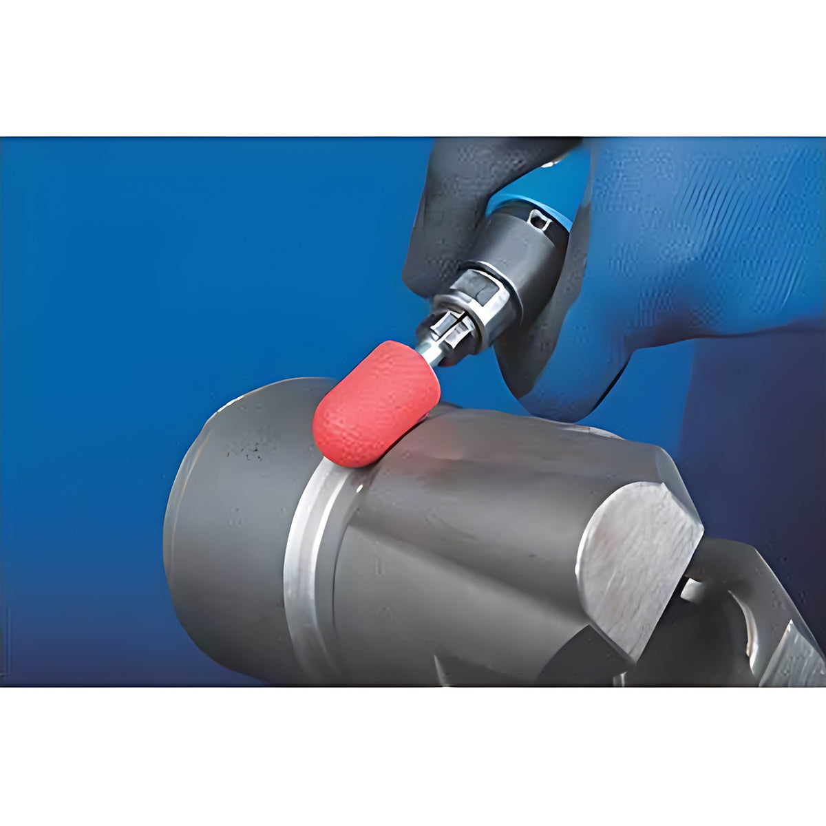 Pferd POLICAP PC WRC CO-COOL cap, red cap on an air tool in a gloved hand against a grey steel part, blue background, working shot