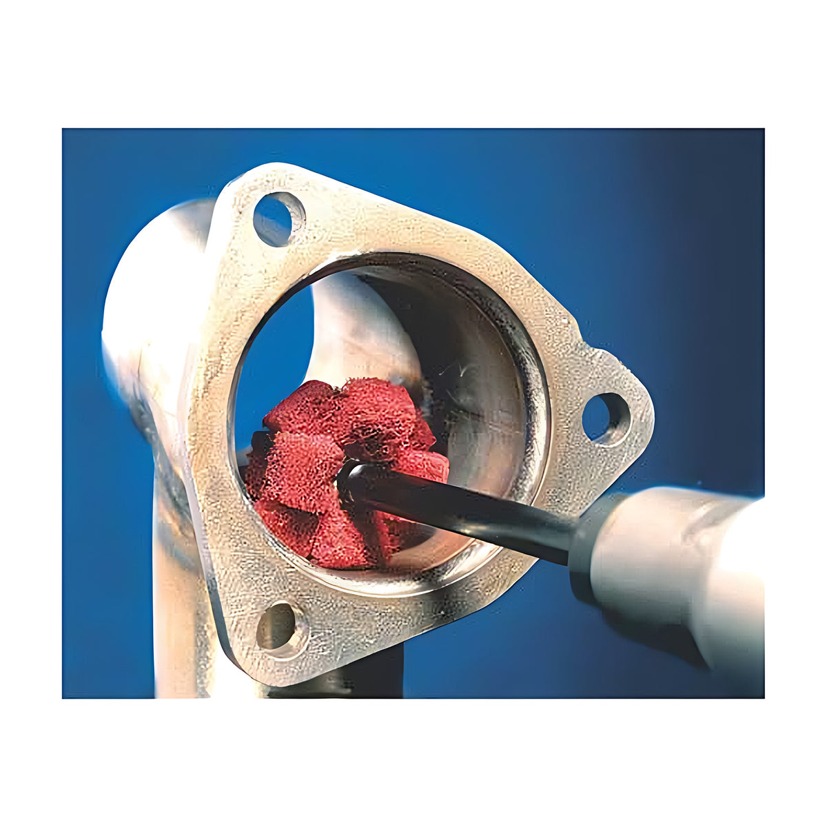 Pferd POLINOX PNST cross buff in use, red buff on a long black shaft cleaning the bore of a flanged metal casting