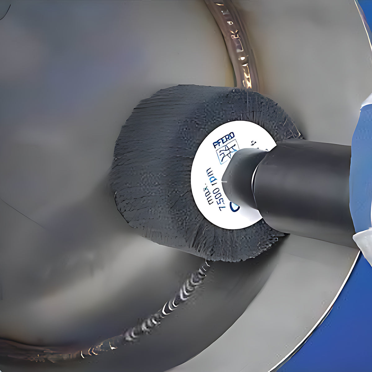 Pferd Polinox PNL mounted wheel on a black extension, polishing the inside of a stainless pipe near a weld, gloved hand